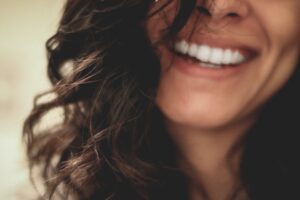 A patient discussing smile options with a dental professional in a bright, welcoming dental office.