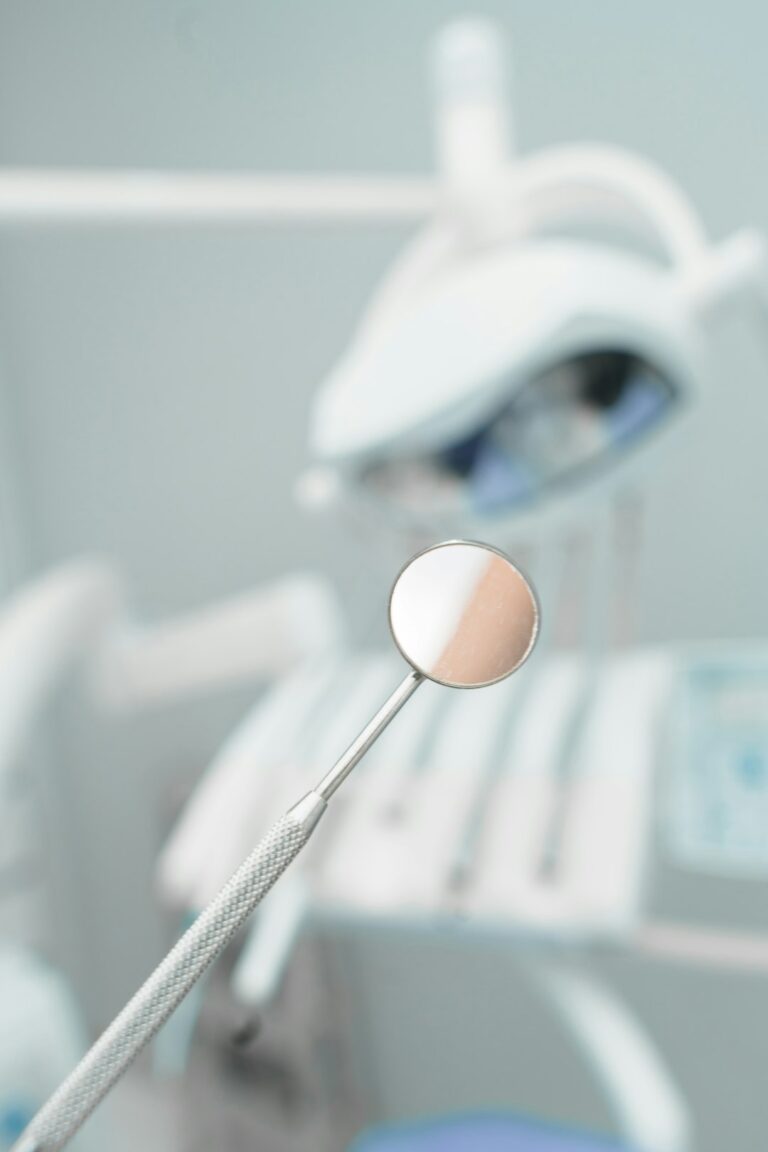 A dental professional discusses a treatment plan with an adult patient in a dental exam room.